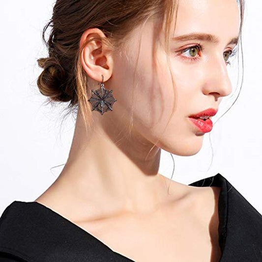 Woman wearing a black star-shaped earring on a white background