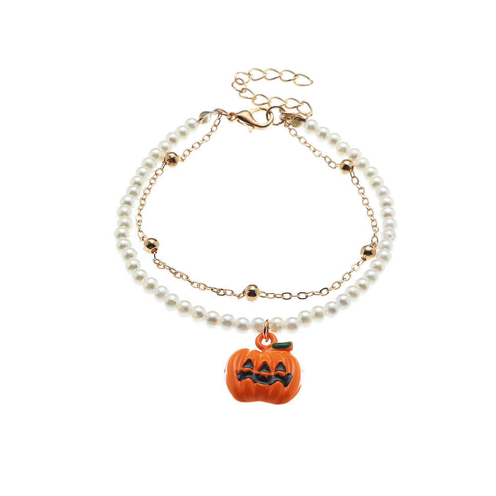 Pearl bracelet with a pumpkin charm on a white background