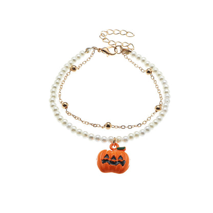 Pearl bracelet with a pumpkin charm on a white background