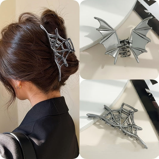 Silver spider web hair clip worn in a bun, close-up of the clip, and on a surface.