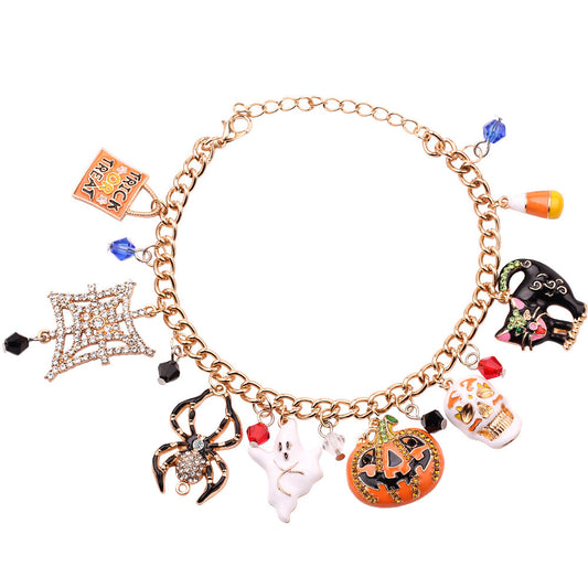 Gold bracelet with Halloween-themed charms on a white background