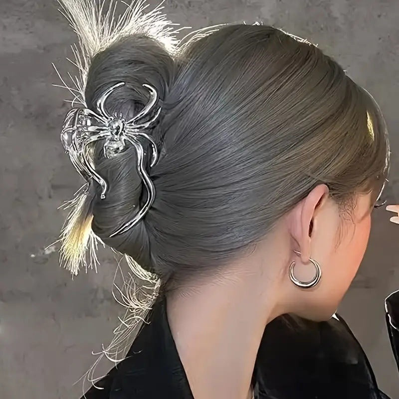 Close-up of a person with intricate hair styling and decorative hairpin on a neutral background