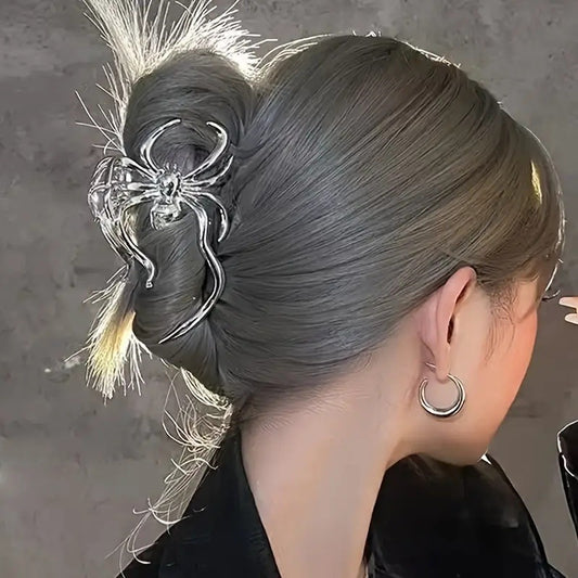 Close-up of a person with intricate hair styling and decorative hairpin on a neutral background