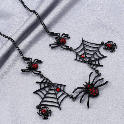 Black spider and web necklace with red accents on a light gray background