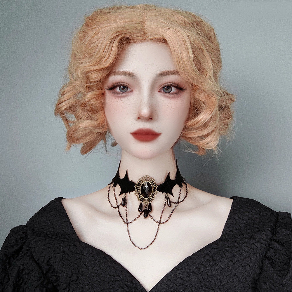 Person wearing a black lace dress and choker with a plain background