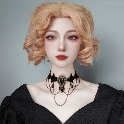 Person wearing a black lace dress and choker with a plain background