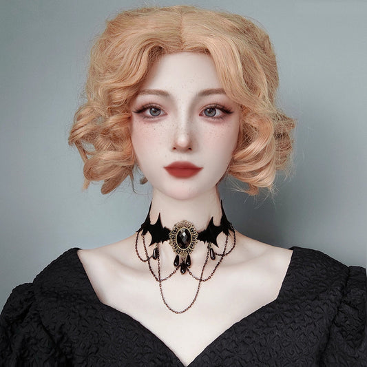 Person wearing a black lace dress and choker with a plain background