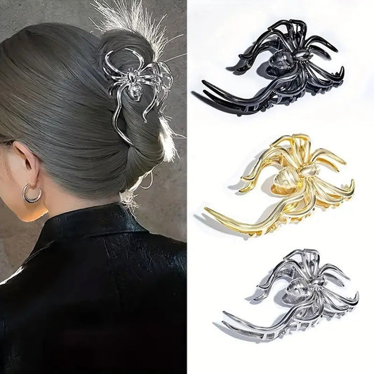 Spider-shaped hair clip worn in a gray hair bun with additional clips shown in black, gold, and silver on a white background.